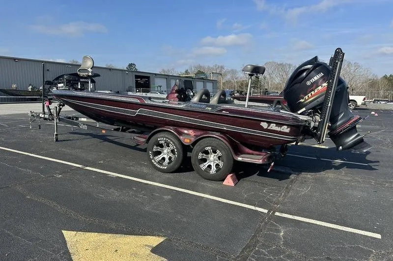 Slide: The Image of 2014 Bass Cat Puma FTD boat on trailer in parking lot, clear sky background. - 9