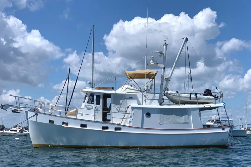 The Image of 2008 Kadey-Krogen 44 yacht on calm waters under blue sky. - 0