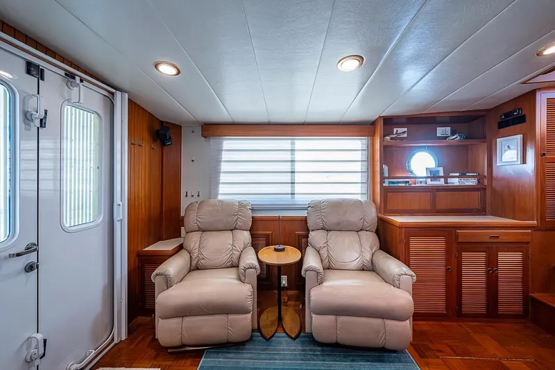 Slide: The Image of Luxurious interior of 2008 Kadey-Krogen 44 yacht with plush recliners and wooden cabinetry. - 10