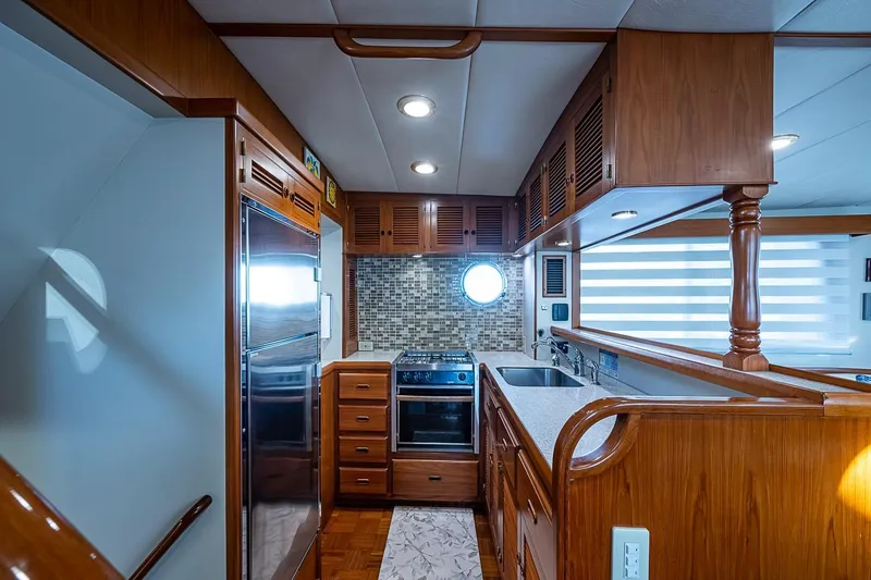 Slide: The Image of Luxurious 2008 Kadey-Krogen 44 yacht kitchen with wood cabinetry and modern appliances. - 12