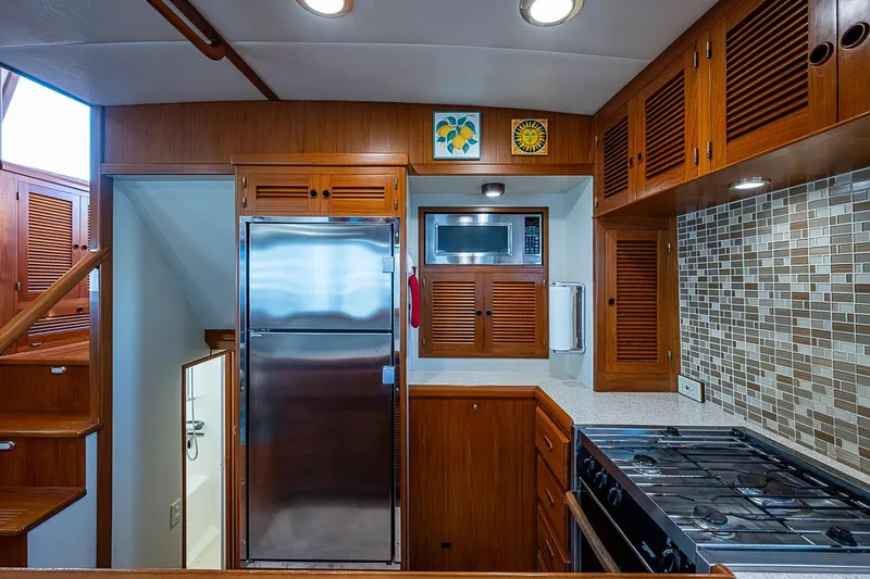 Slide: The Image of Luxurious 2008 Kadey-Krogen 44 yacht kitchen with wood cabinetry and modern appliances. - 13