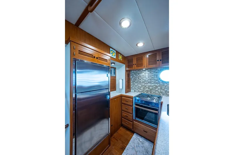 Slide: The Image of Luxurious 2008 Kadey-Krogen 44 yacht kitchen with stainless steel appliances and wood cabinetry. - 14