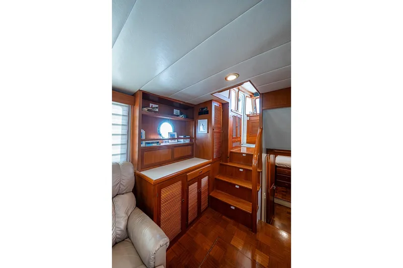 Slide: The Image of Interior of 2008 Kadey-Krogen 44 yacht with wooden stairs and built-in shelving. - 16