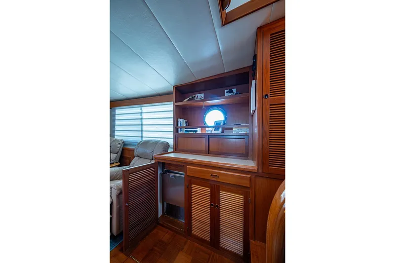 Slide: The Image of Luxurious interior of 2008 Kadey-Krogen 44 yacht with wooden cabinetry and porthole window. - 17
