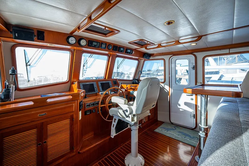 Slide: The Image of Pilothouse interior of 2008 Kadey-Krogen 44 yacht with wooden accents and navigation equipment. - 18