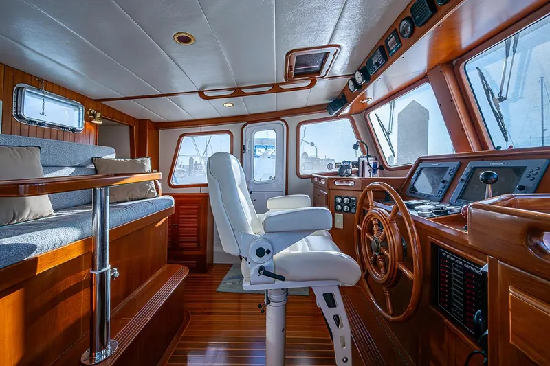 Slide: The Image of Luxurious 2008 Kadey-Krogen 44 yacht interior with wooden helm and seating area. - 23