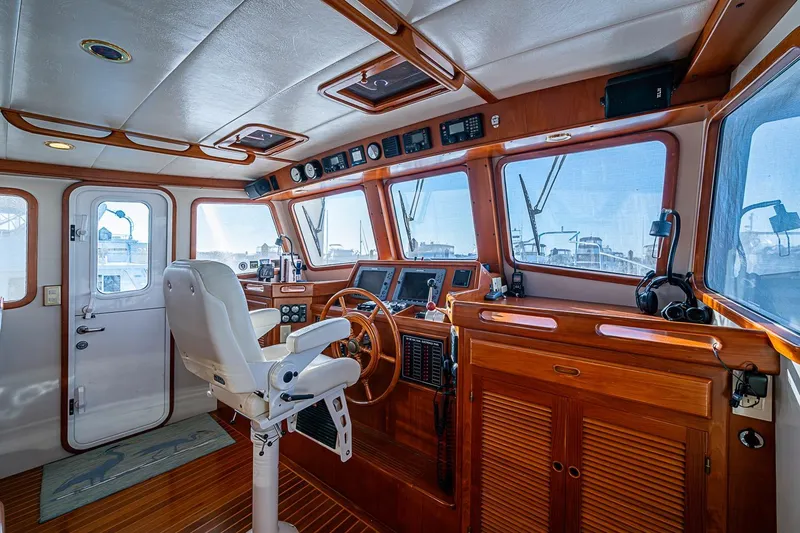 Slide: The Image of Pilothouse interior of 2008 Kadey-Krogen 44 yacht with wooden finishes and navigation equipment. - 24
