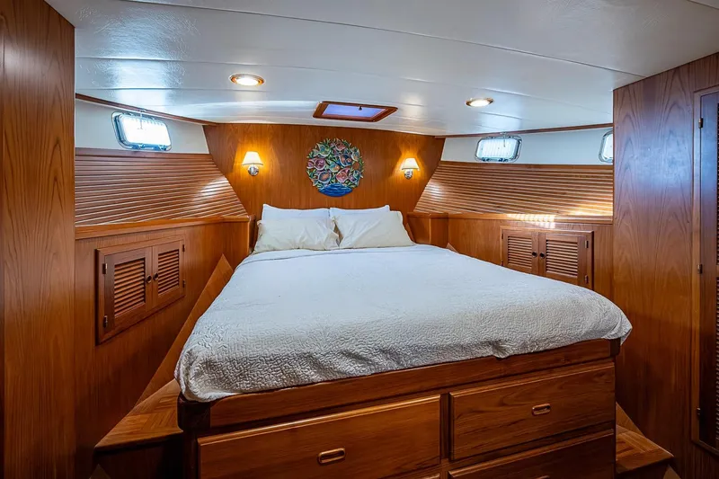 Slide: The Image of Luxurious 2008 Kadey-Krogen 44 yacht bedroom with wood paneling and cozy bedding. - 28
