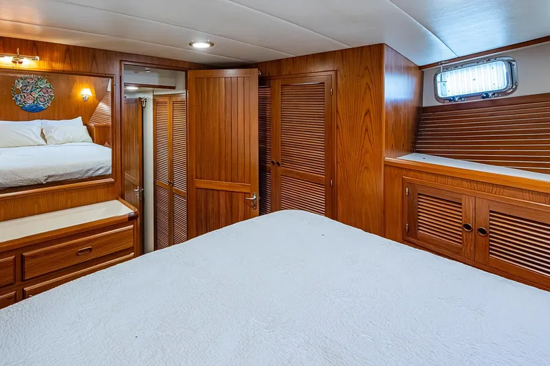Slide: The Image of Luxurious 2008 Kadey-Krogen 44 yacht cabin with elegant wood paneling and cozy bedding. - 30