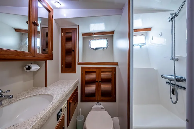 Slide: The Image of Luxurious bathroom in 2008 Kadey-Krogen 44 yacht with shower and wooden cabinetry. - 37