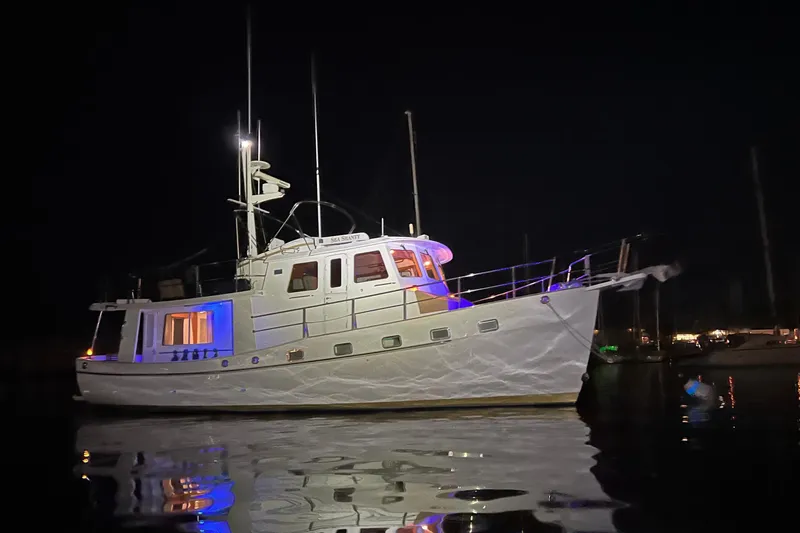 Slide: The Image of 2008 Kadey-Krogen 44 yacht illuminated at night on the water. - 4