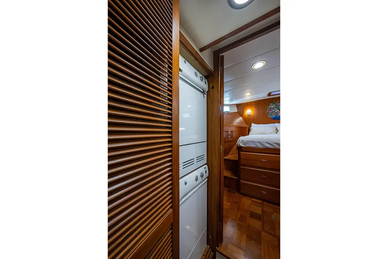 Slide: The Image of Interior of 2008 Kadey-Krogen 44 yacht featuring a cozy bedroom and laundry area. - 43