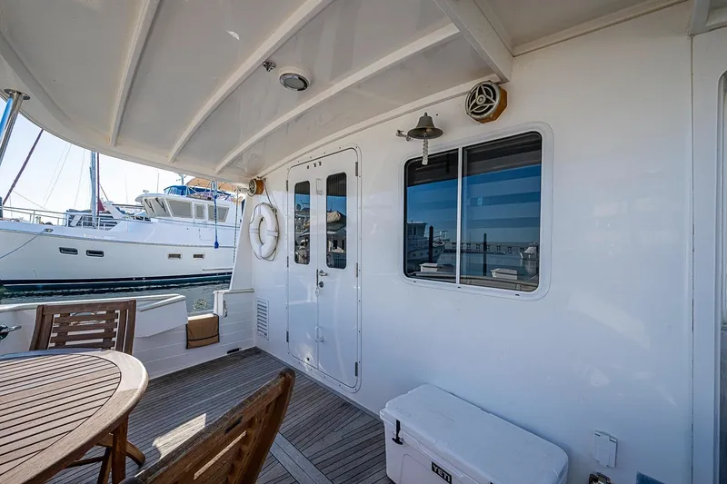 Slide: The Image of Outdoor deck of 2008 Kadey-Krogen 44 yacht with wooden furniture and ocean view. - 44