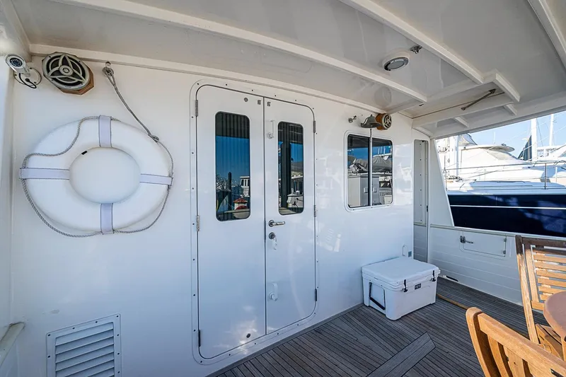 Slide: The Image of 2008 Kadey-Krogen 44 yacht deck with life preserver and seating area. - 45