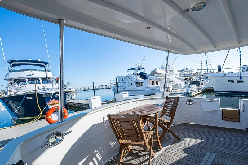 Slide: The Image of 2008 Kadey-Krogen 44 yacht docked at marina with wooden deck chairs. - 46