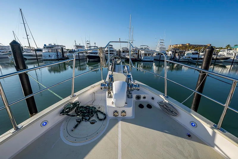 Slide: The Image of Bow view of 2008 Kadey-Krogen 44 yacht docked in a marina under clear blue skies. - 50
