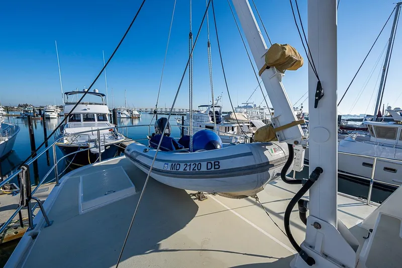 Slide: The Image of 2008 Kadey-Krogen 44 yacht with dinghy docked in a marina. - 54
