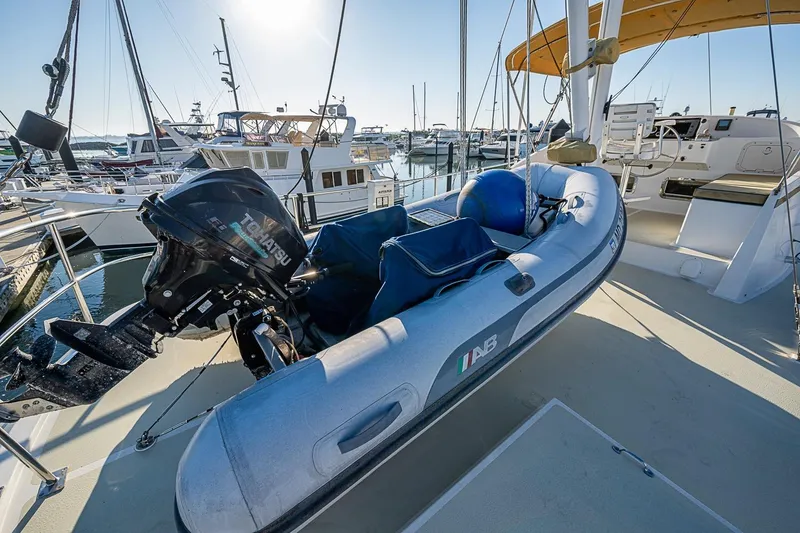 Slide: The Image of Inflatable boat with Tohatsu motor on 2008 Kadey-Krogen 44 yacht deck in marina. - 57