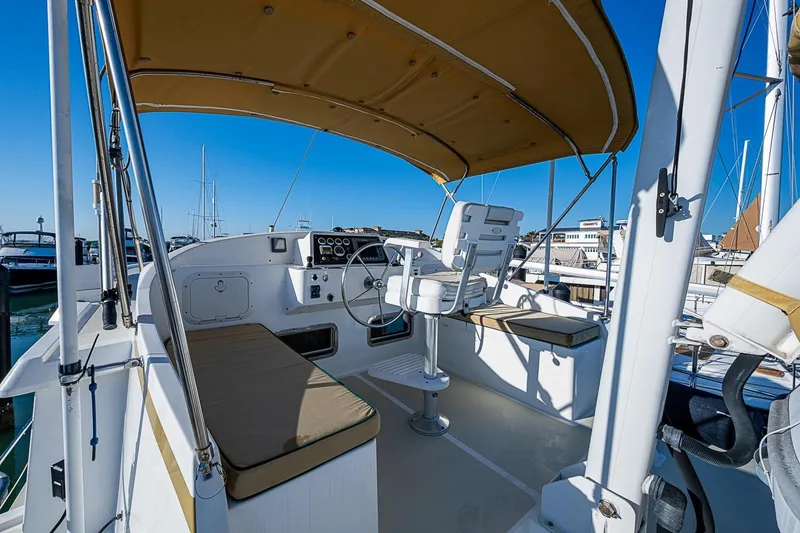 Slide: The Image of Helm of 2008 Kadey-Krogen 44 yacht with seating and canopy in marina. - 61