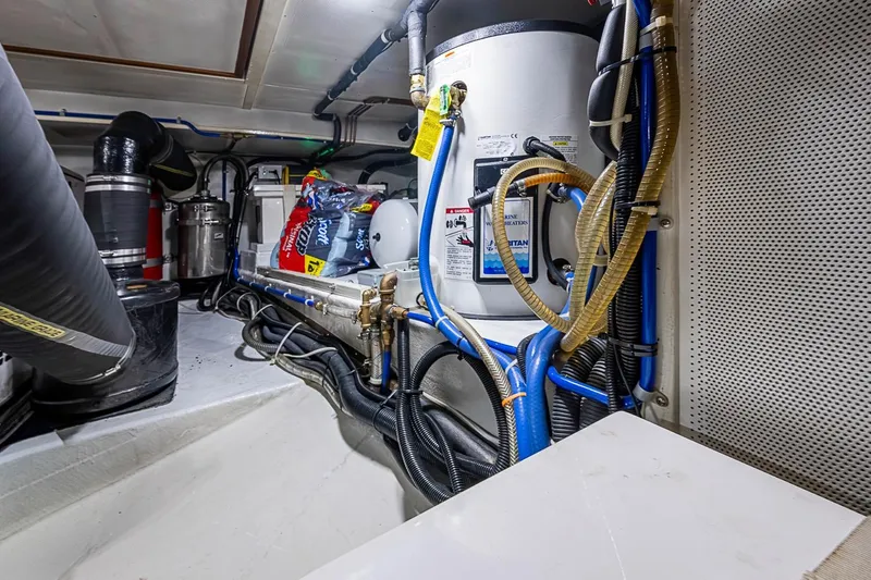 Slide: The Image of Engine room of 2008 Kadey-Krogen 44 yacht with visible pipes and equipment. - 69