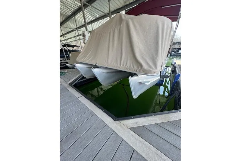 Slide: The Image of Covered 2016 Crest 2360 SLC boat docked in a marina. - 14