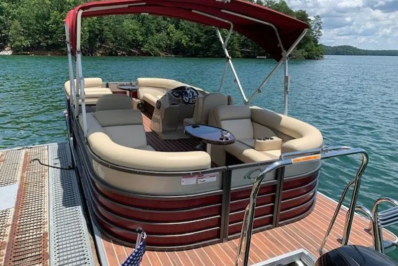 Slide: The Image of 2016 Crest 2360 SLC pontoon boat docked on a scenic lake. - 3