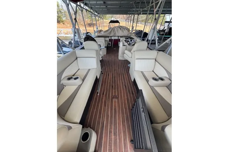 Slide: The Image of 2016 Crest 2360 SLC boat interior with beige seating and wood flooring. - 5
