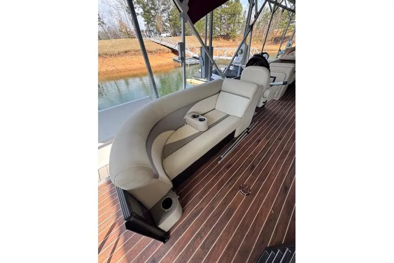 Slide: The Image of Luxurious seating on 2016 Crest 2360 SLC boat with wooden deck and cup holders. - 7