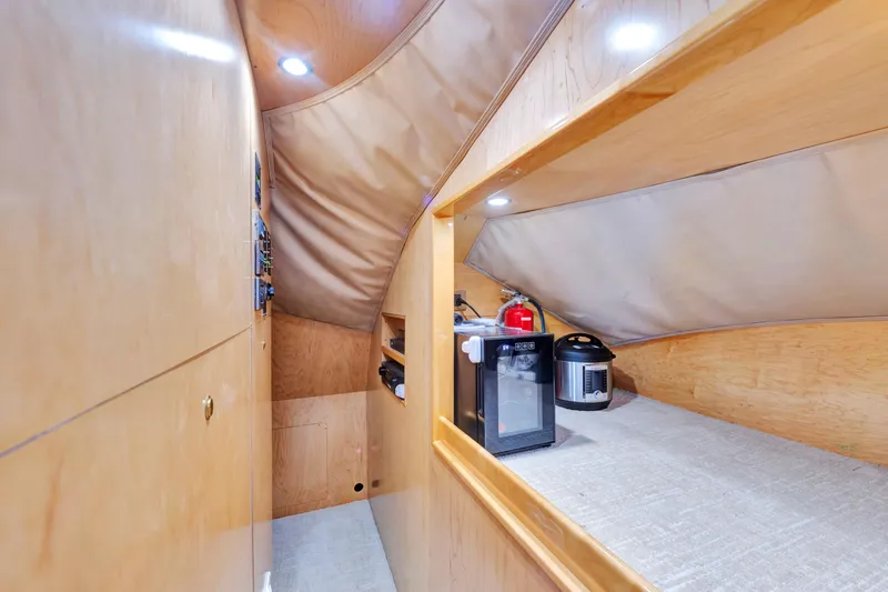 Slide: The Image of Interior of 2011 Viking 70 Convertible yacht with wooden cabinetry and compact appliances. - 10