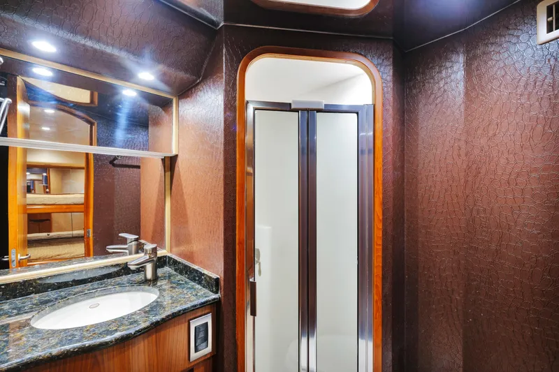 Slide: The Image of Luxurious bathroom in 2011 Viking 70 Convertible yacht with elegant wood and granite finishes. - 17