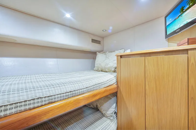 Slide: The Image of Cozy cabin interior of 2011 Viking 70 Convertible yacht with bunk bed and TV. - 19