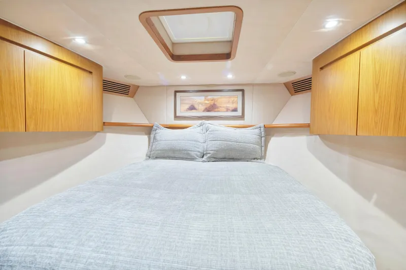 Slide: The Image of Luxurious bedroom interior of 2011 Viking 70 Convertible yacht with wood cabinets and skylight. - 23