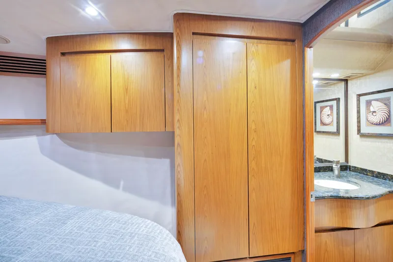 Slide: The Image of Luxurious 2011 Viking 70 Convertible yacht interior with wood cabinetry and modern bathroom. - 25