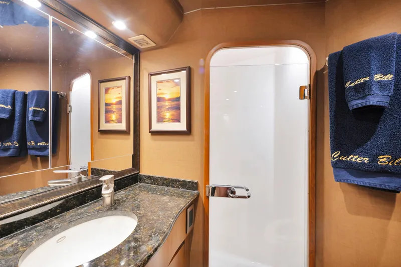 Slide: The Image of Luxurious bathroom in 2011 Viking 70 Convertible yacht with elegant decor and plush towels. - 26