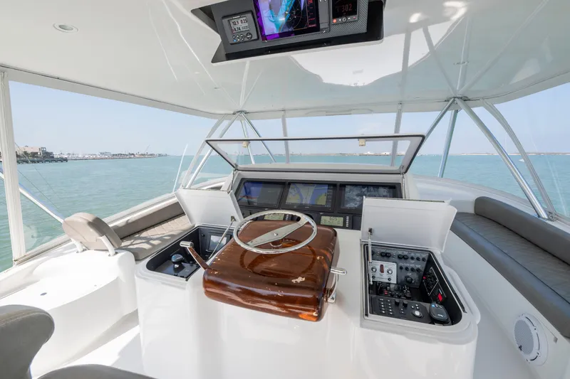Slide: The Image of Luxurious wood interior of 2011 Viking 70 Convertible yacht with open storage compartment. - 34
