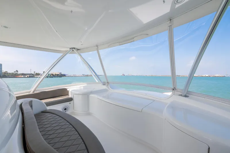 Slide: The Image of Cockpit view of 2011 Viking 70 Convertible yacht with navigation screens and ocean backdrop. - 39