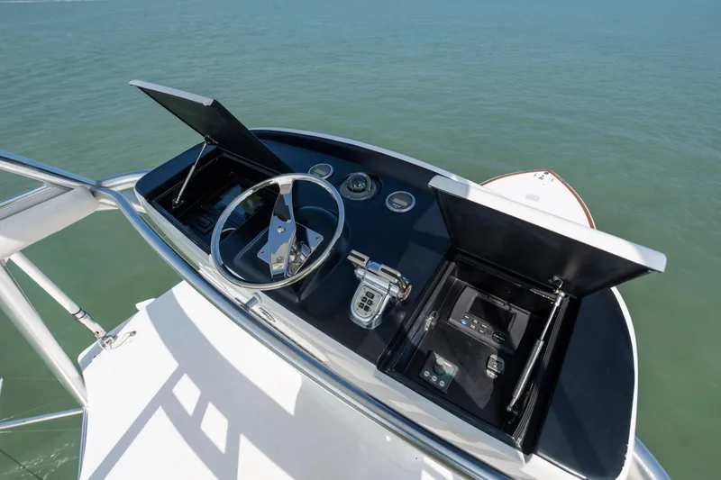 Slide: The Image of Helm of 2011 Viking 70 Convertible yacht with ocean view and navigation controls. - 48