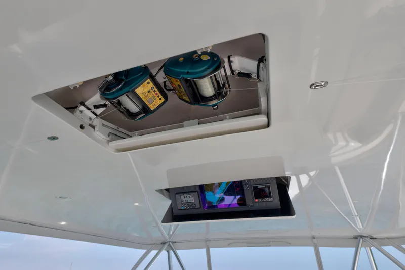 Slide: The Image of Helm of 2011 Viking 70 Convertible yacht with steering wheel and control panels. - 51