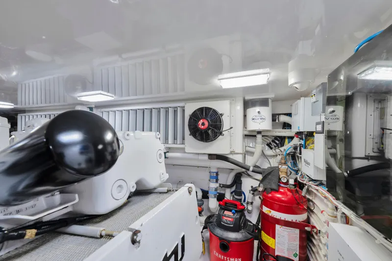 Slide: The Image of 2011 Viking 70 Convertible yacht cruising on open water under clear blue skies. - 59