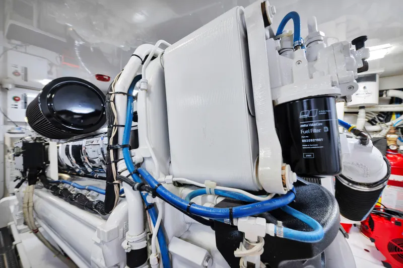 Slide: The Image of Engine room of 2011 Viking 70 Convertible yacht, showcasing fuel filter and intricate piping. - 65