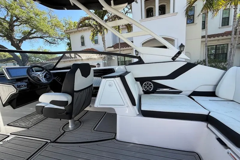 Slide: The Image of 2024 Yamaha Boats 252SE interior with sleek seating and modern dashboard design. - 10