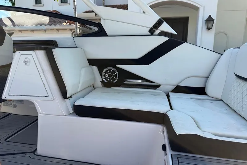 Slide: The Image of 2024 Yamaha Boats 252SE interior seating with modern design and speaker detail. - 11