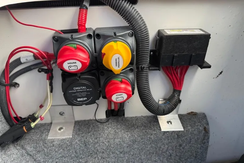 Slide: The Image of Electrical panel of 2024 Yamaha Boats 252SE with switches and wiring. - 19