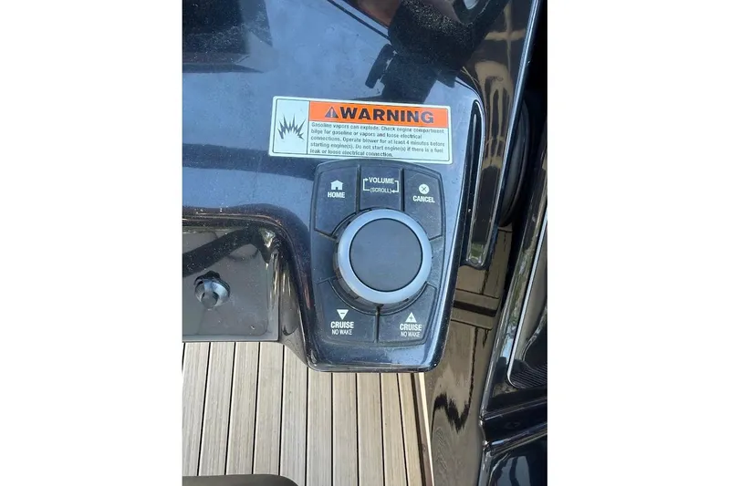 Slide: The Image of Control panel of 2024 Yamaha Boats 252SE with warning label and navigation buttons. - 25