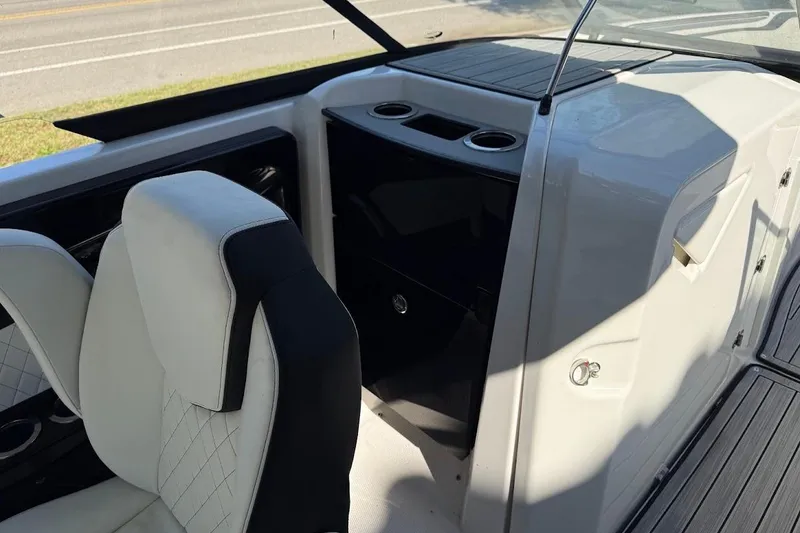 Slide: The Image of 2024 Yamaha Boats 252SE interior with white seating and sleek dashboard design. - 9