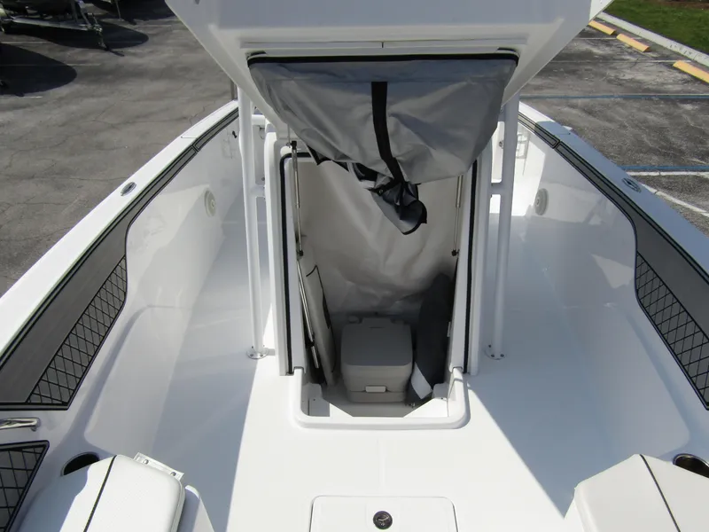 Slide: The Image of 2024 Wellcraft 202 Fisherman boat interior with storage compartment and seating. - 9