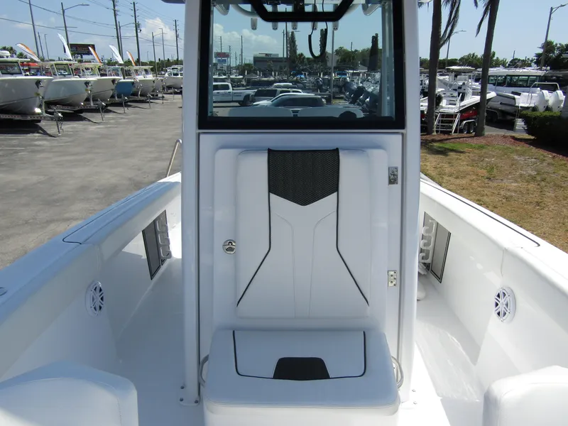 Slide: The Image of 2024 Wellcraft 243 Fisherman boat interior, featuring a center console and seating. - 16