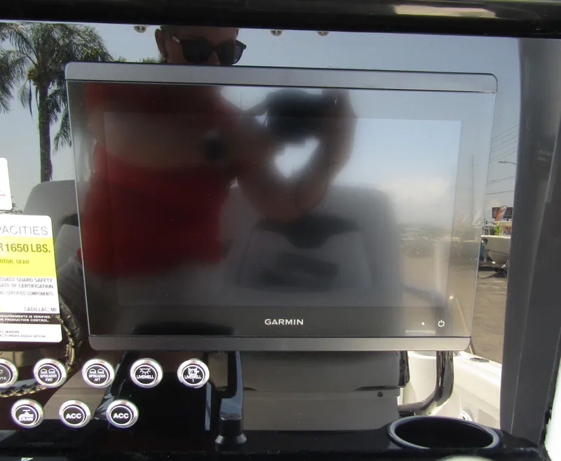 Slide: The Image of Garmin display on 2024 Wellcraft 243 Fisherman boat dashboard with control buttons. - 27