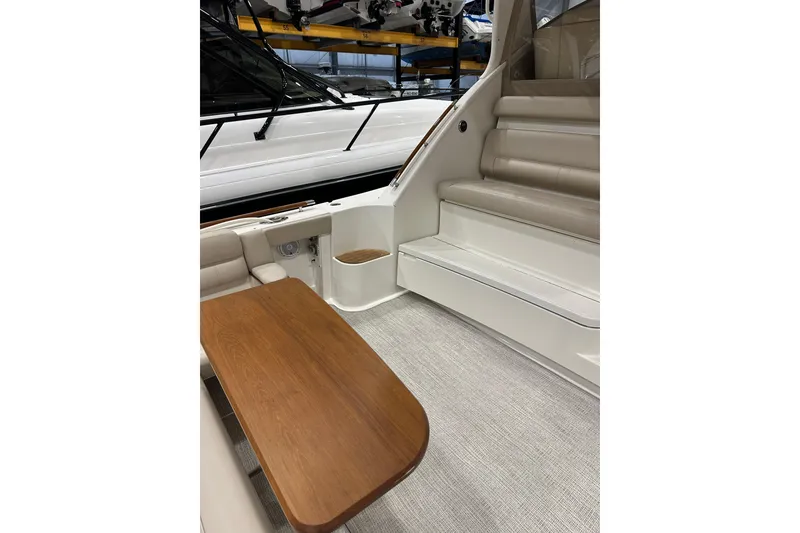 Slide: The Image of 2014 Tiara Yachts 4300 Open interior with wooden table and cushioned seating. - 26