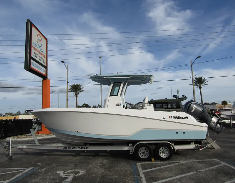 The Image of 2025 Wellcraft 243 Fisherman boat on trailer in parking lot. - 1